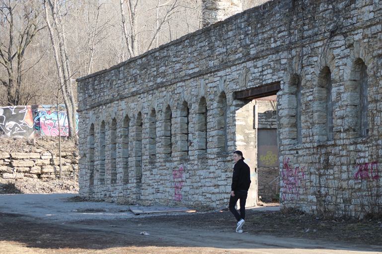 Senior Julian Niewiadomski walking towards the Kansas City Workshop building on Feb. 24.