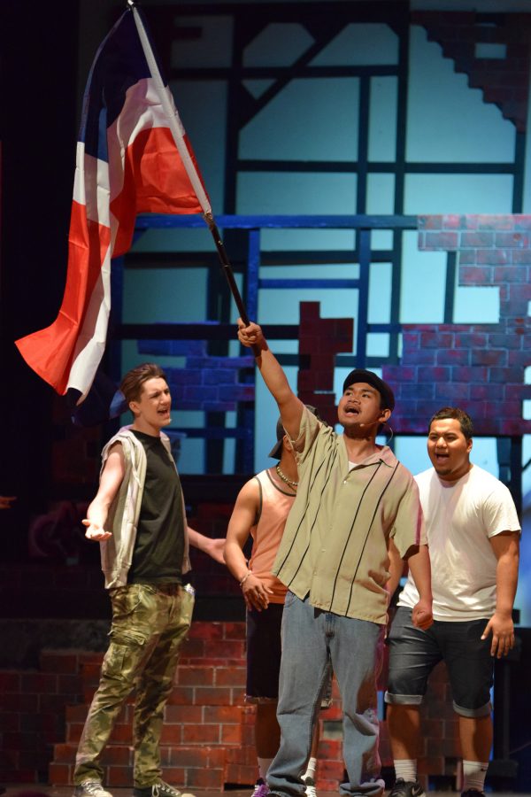 Eldridge Velagas as Usnavi from In the Heights raises the Cuban flag during the song Carnaval Del Barrio.