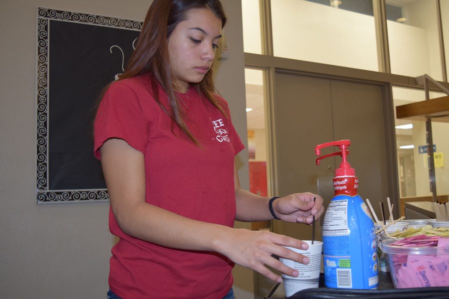 Sophomore Jordyn Turncheck at Griffin Grounds adding creamer to her coffee on Nov. 7.