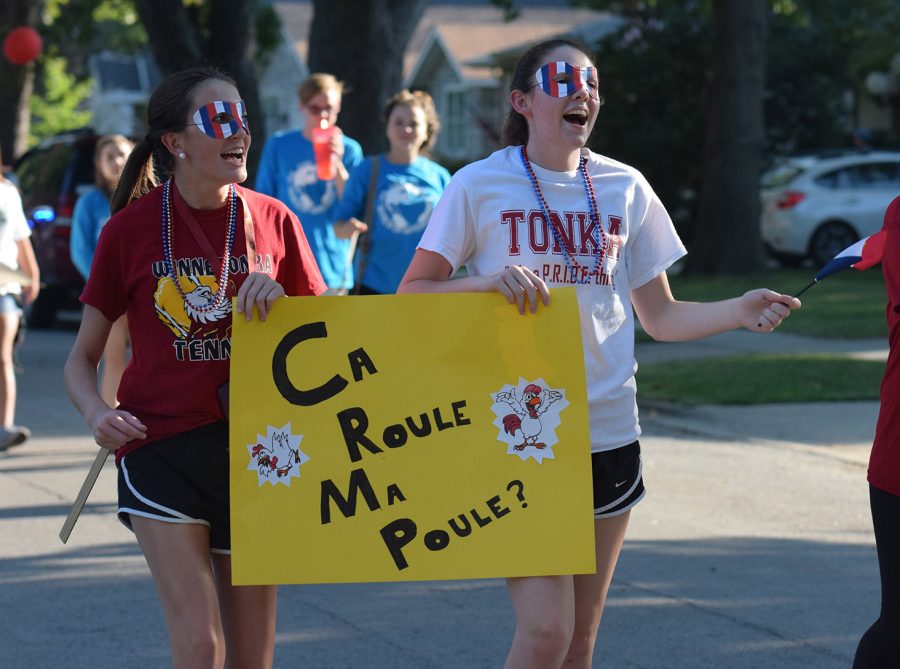 Sophomores Emma Jameson and Maggie Williams walking in the homecoming parade with the French Club on Sept. 23.