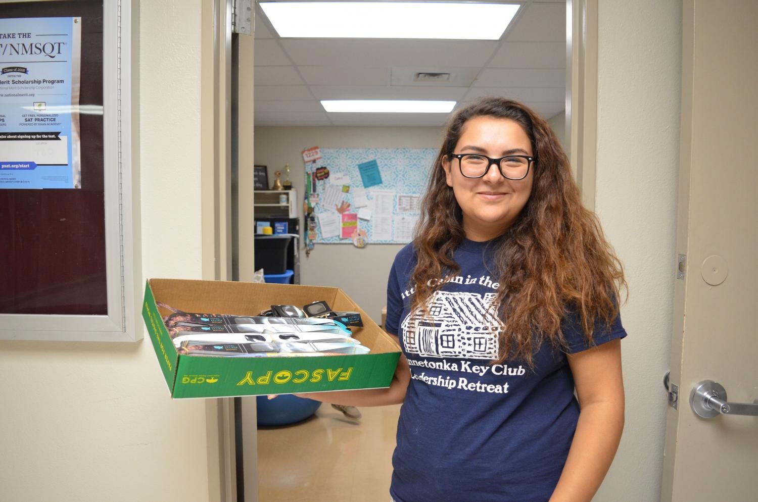Senior Hannah Hernandez, the president of Key Club, holds a box with some the glasses collected.