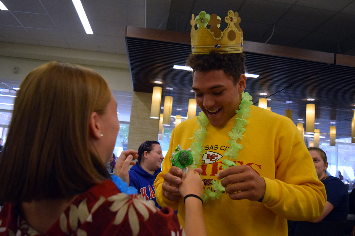 Senior Michael Small receives suckers from junior Makenzie Jackson as he is crowned a homecoming candidate. 
