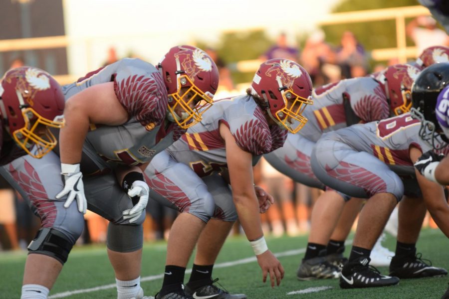 Junior Traveon Franke (left) lines up with the other varsity football players as they prepare to play against Park Hill South on August 18. Photo by KatieBullock
