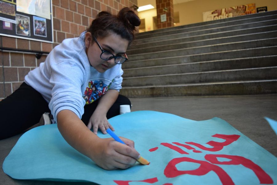 Above: Senior Hannah Hernandez paints a water droplet poster for Key Club’s awareness campaign about the global water crisis.
