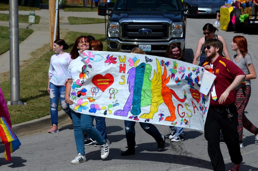Junior Regan SmithMcLey and English teacher James Hawes walk with Gay-Straight Alliance in the homecoming parade on Sept. 29.