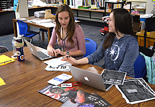 J2 Multimedia Editor-in-Chief Katie Bullock & Print Editor Jessica Glaszczak discuss Griffin Rites page edits during class on Jan. 18. 