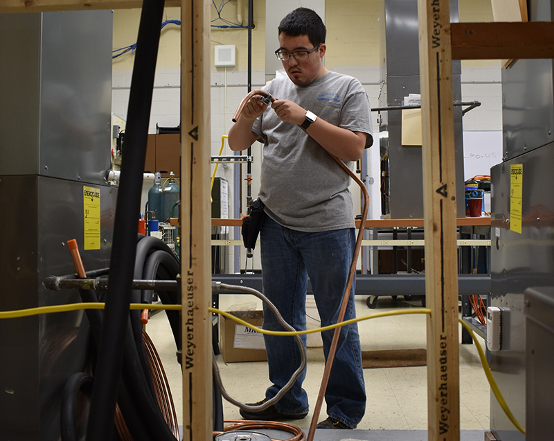  Senior Payton Stephenson works on a part for a heating and cooling system on Dec. 7 at the Northland Career Center in the Heating, Ventilation, Air Conditioning, and Refigeration class.  