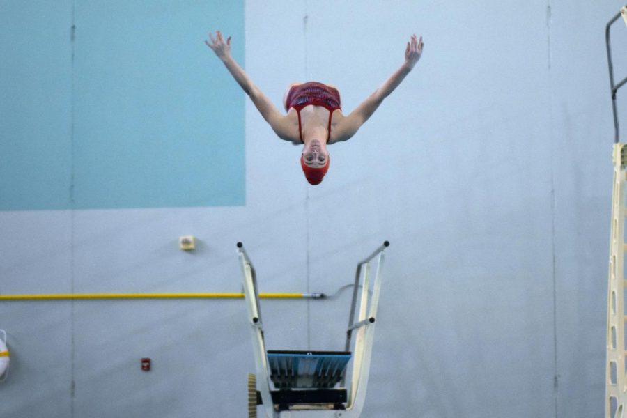 Junior Eden Viles looks forward during a backward summersault at the Jan. 9 meet at the Gladstone Community Center where she took first place.