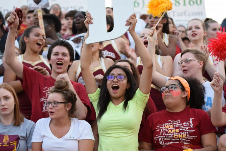 At the football game against Park Hill South on Aug. 18, the first home game of the season, senior Harper Ross (see page 16) cheers while holding the 