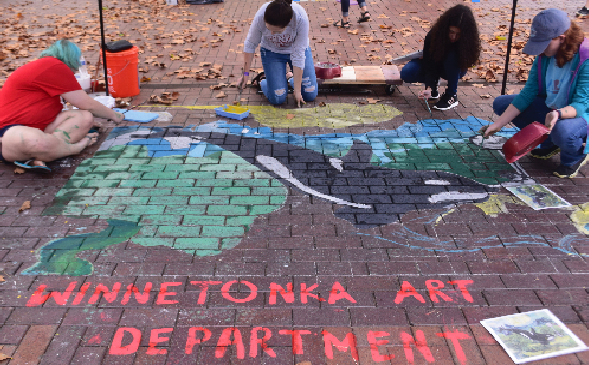 Photo to the right: Winnetonka art students paint in an orca on the sidewalk at Crown Center. Last school year, art students chose this image to recreate at the  September festival. Photo by Elizabeth Payton