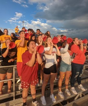 Seniors Lan Linh Tran, Kayla Blank, Elle Snider, and Mackenna Kutter cheer the Tonka football team at the annual jamboree on Aug. 19, 2022. Picture by Cheyenne Brown.